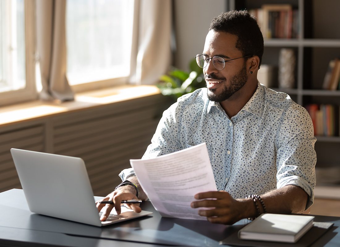 Resources - A Man is Using a Laptop to do Research at His Desk